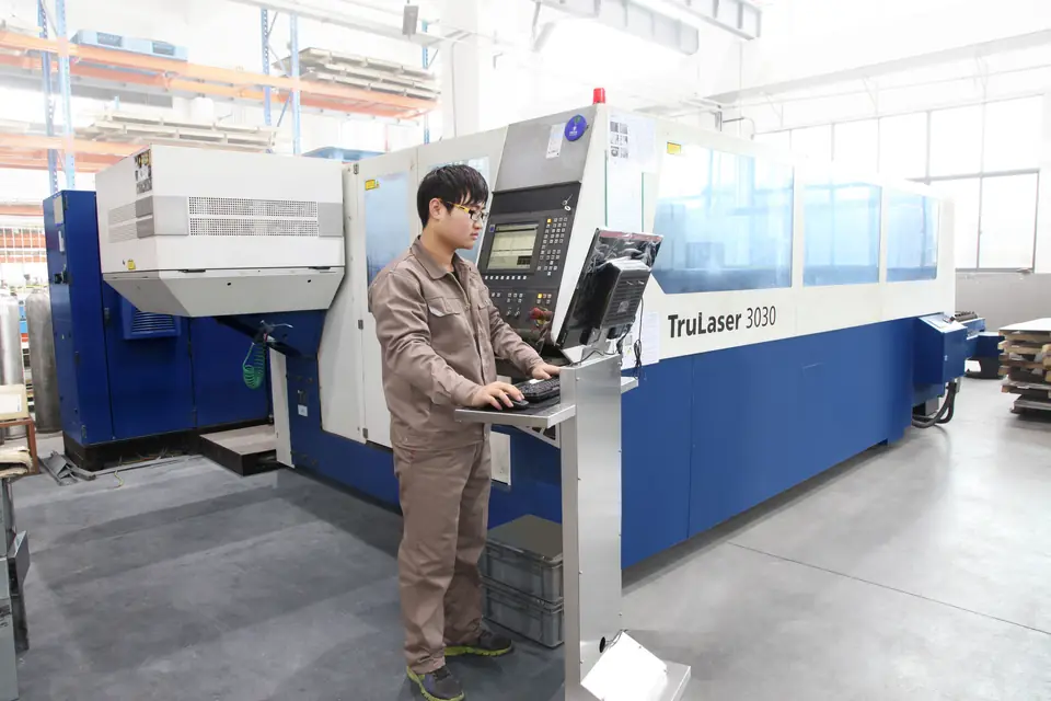 Laser cutting equipment processing metal sheet in the workshop
